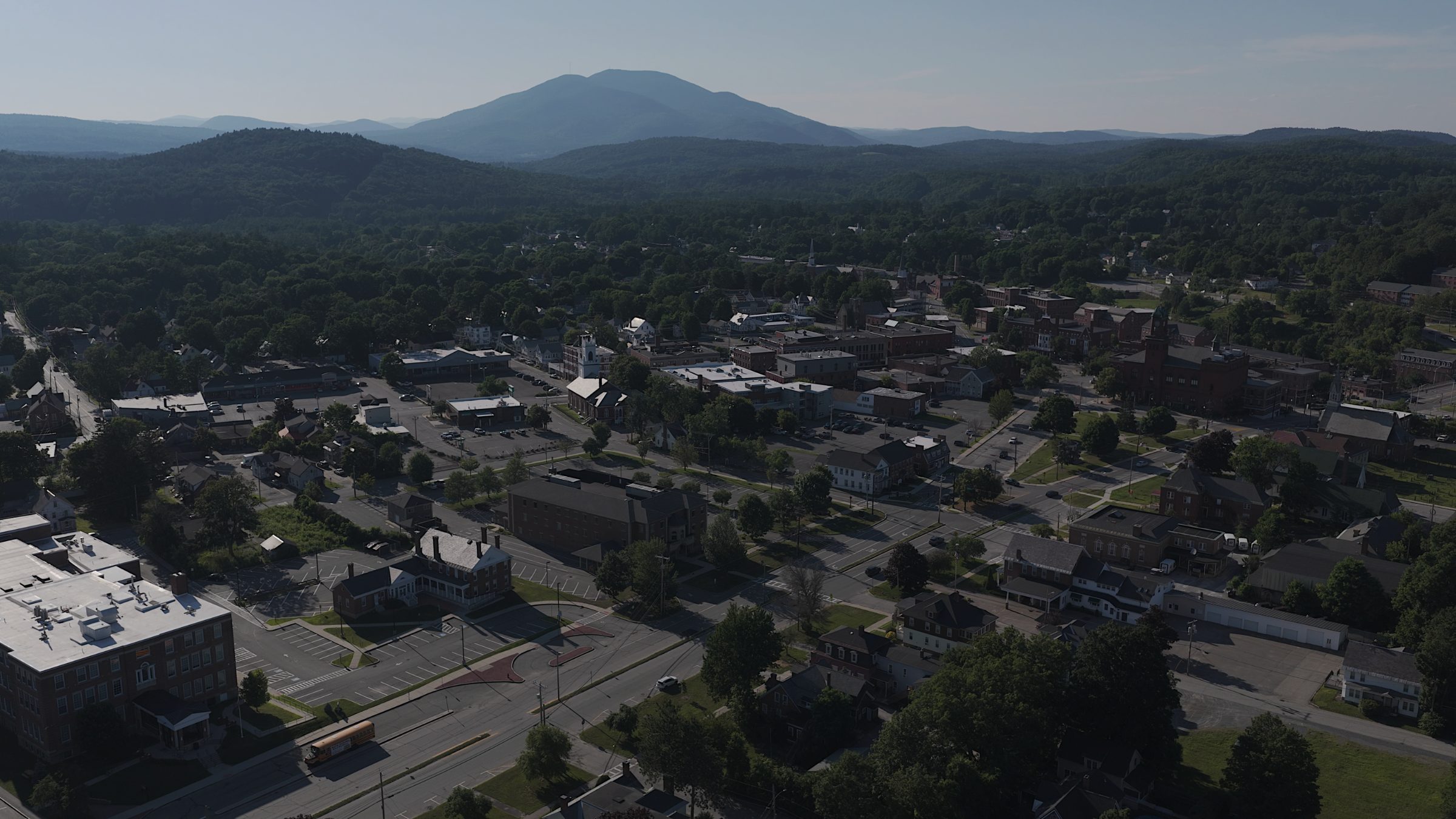 Claremont downtown with Mount Ascutney rising in haze behind