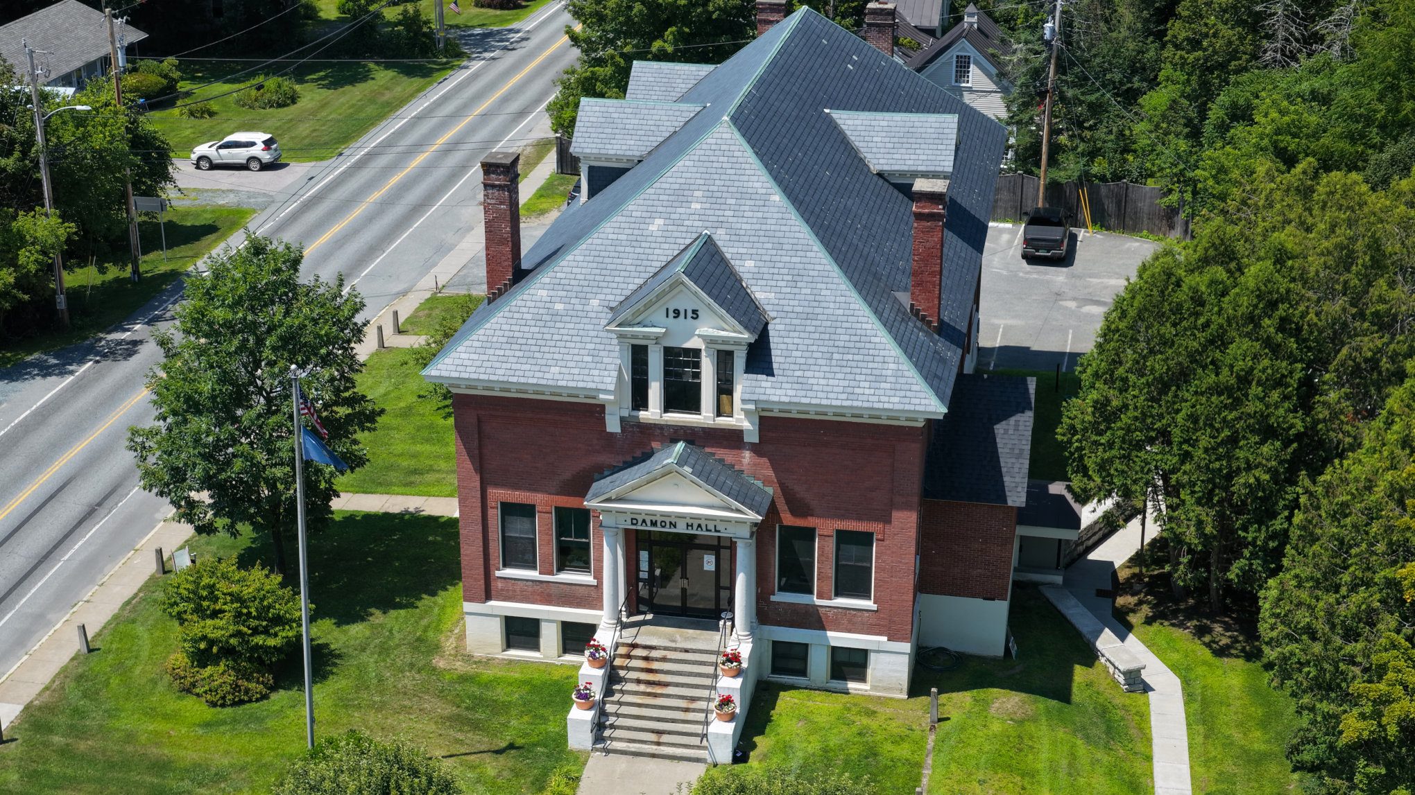 Damon Hall in Hartland, Vermont, seen from above with its slate roof and brick facade
