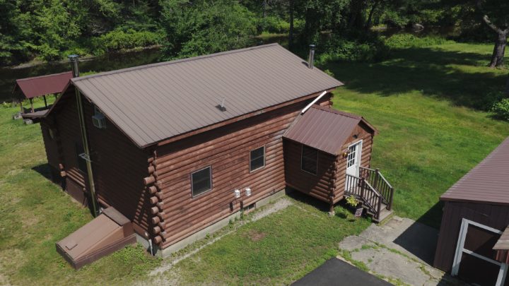 High-angle aerial view of a log cabin exterior